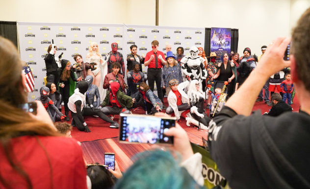 Fans crowd around to take photos at the Marvel Cosplay Meetup as the group of fans pose. 