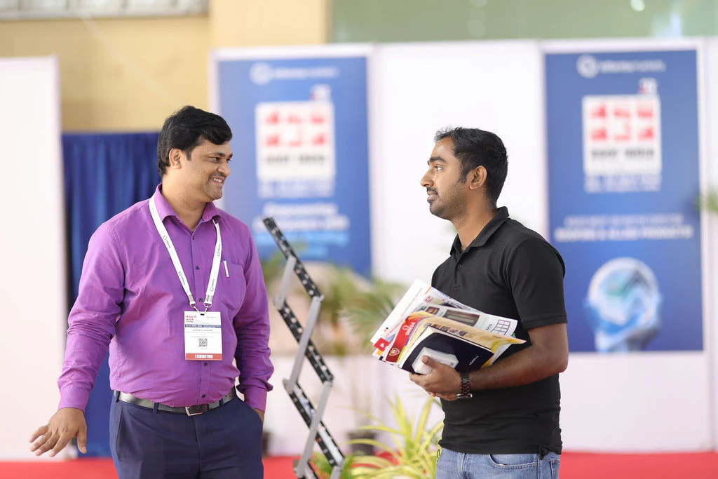 Attendees walking along the aisles between exhibition booths at Roof India 2025