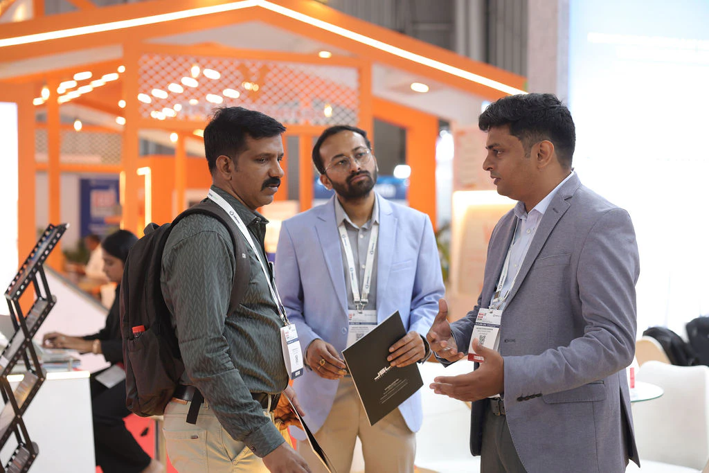 Attendees walking along the aisles between exhibition booths at Roof India 2025