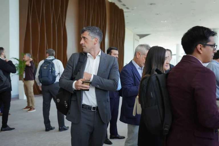 Attendees networking in the lobby area during the event.