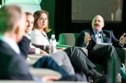 Speakers on a panel onstage at the Investor Summit