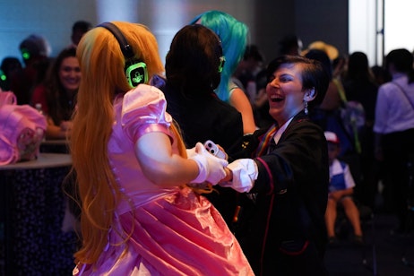 Two fans laughing while dancing