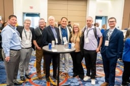 Group of 8 posing for a photo on the Healthcare Waste Conference Show Floor