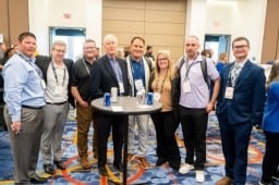 Group of 8 posing for a photo on the Healthcare Waste Conference Show Floor