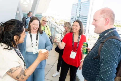 Group of people talking and laughing at the public sector reception