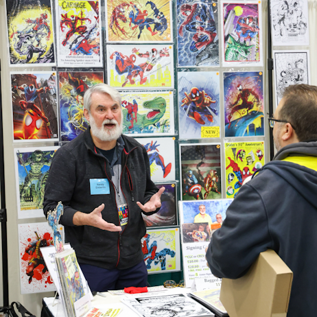 Comic vendor talking with a customer