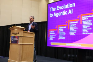 A speaker presents insights on agentic AI during a Solutions Spotlight Theater session at HDI Service & Support World.