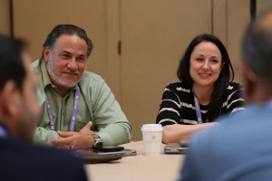 Conference attendees collaborate and exchange ideas during a session, combining deep learning with valuable peer networking opportunities.