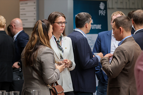 two women and a man gathered at the drinks reception