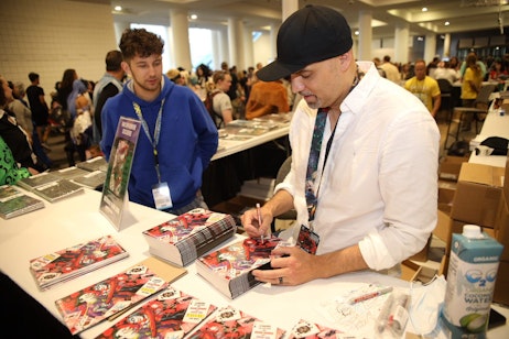 Fans line up as Jonboy Meyers signs copies of his variant cover of Batman Mad Love #1.