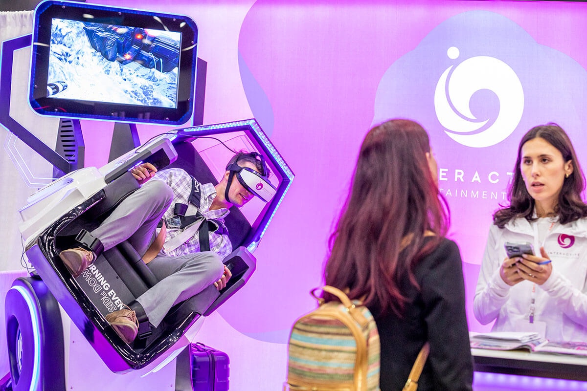 Two women meeting in VR booth on trade show floor