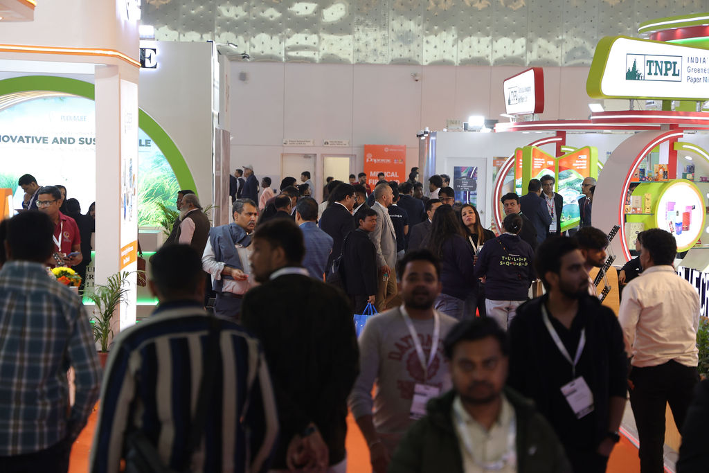 Attendees walking through the corridor, exploring various booths on display at Paperex