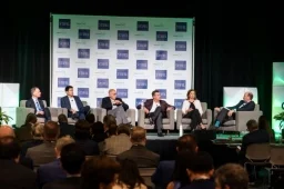 Full panel of 5 speakers with Michael Hoffman onstage at the Investor Summit