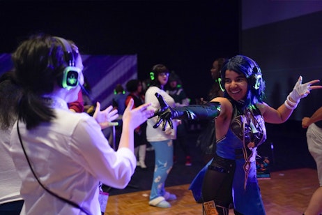 Two fans smiling while dancing