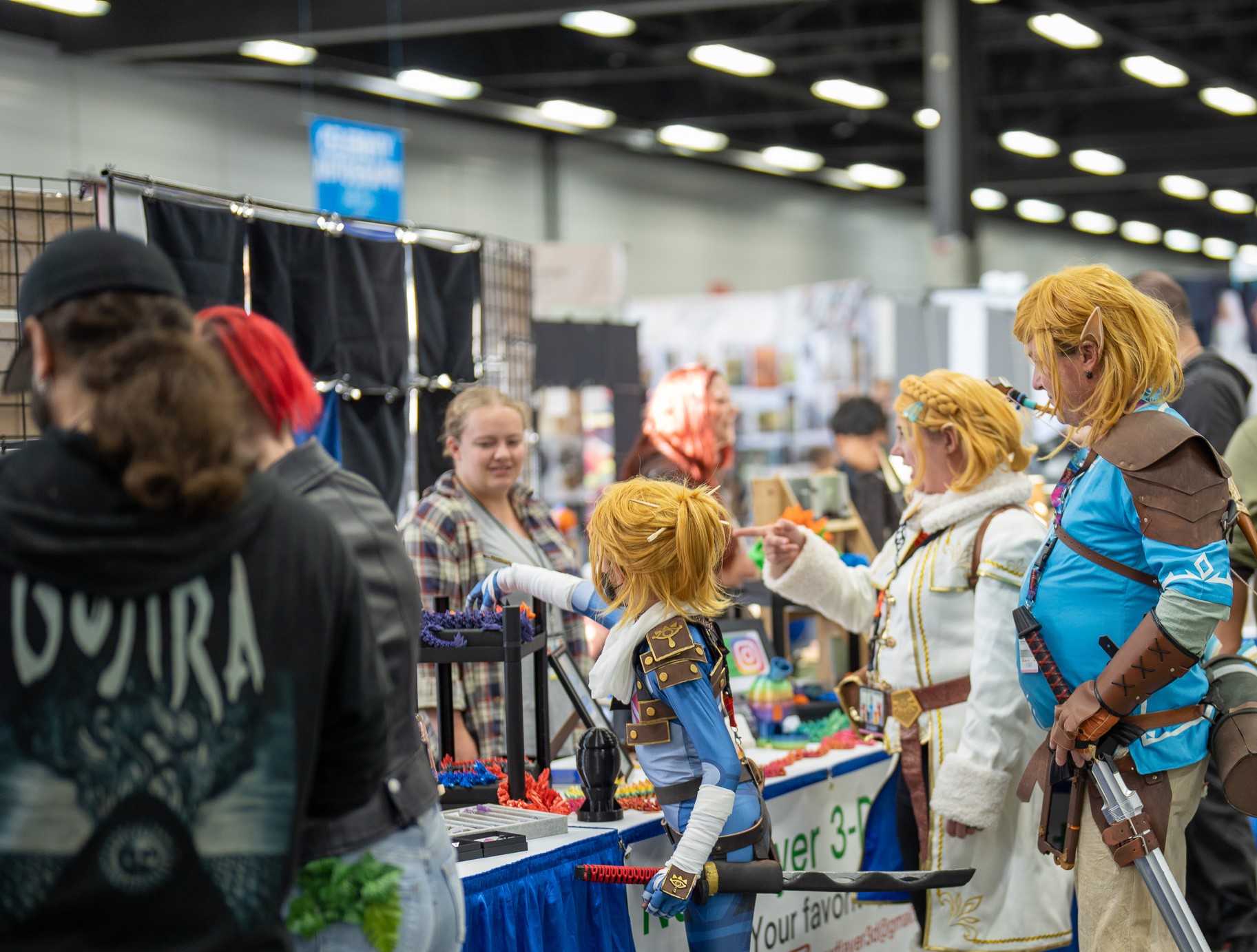 Family of characters in cosplay as they look at 3-D Printed Dragons