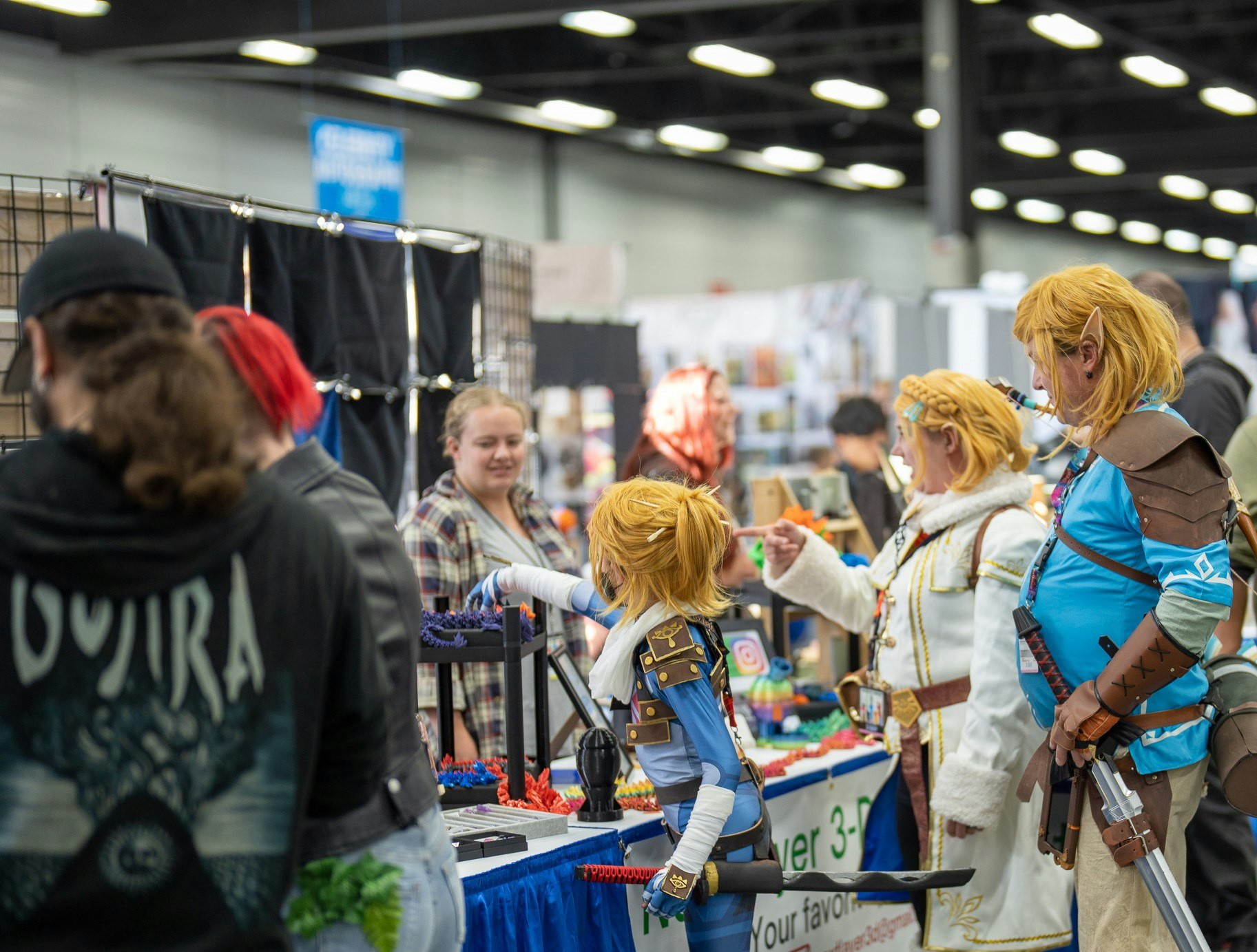 Family of characters in cosplay as they look at 3-D Printed Dragons