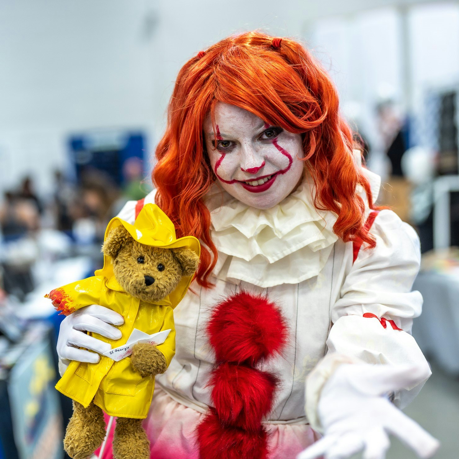 Penywise the clown with a teddy bear dressed as Georgie