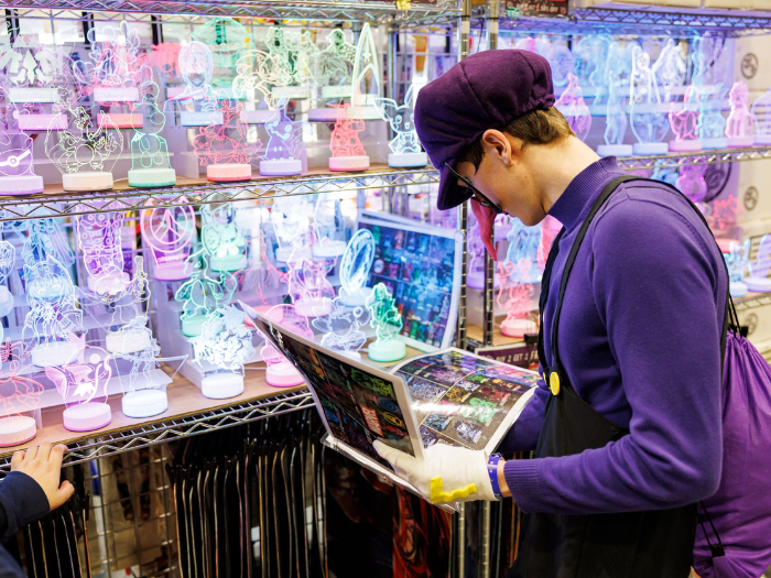 Waluigi shopping at a light-up glass standee booth