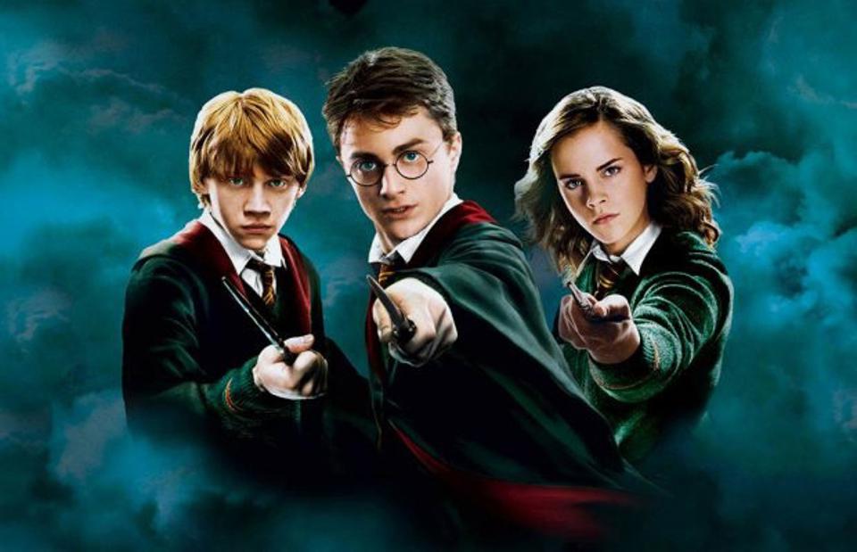 Harry, Ron and Hermione from Harry Potter emerge from a cloud of smoke and point their wands forward