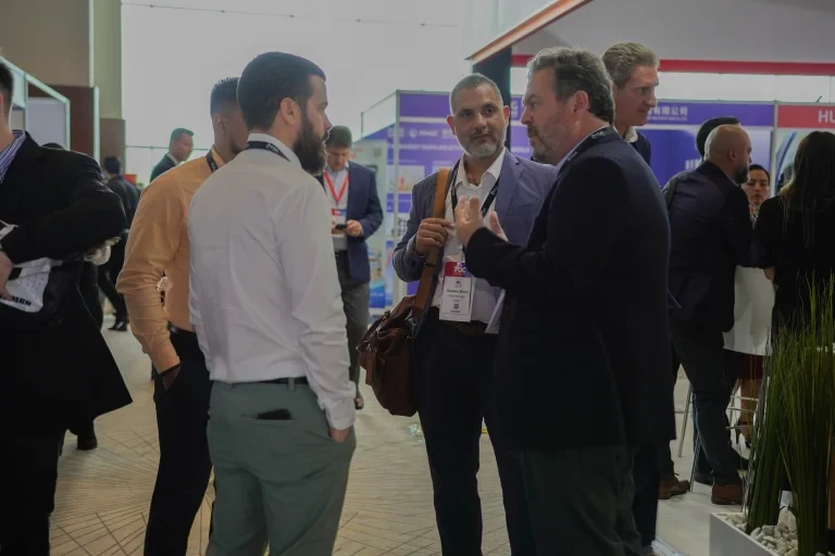 Participants discussing business at an event networking area.