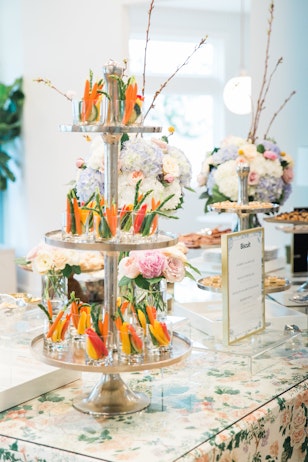 3 tier tray stand with cups of salad
