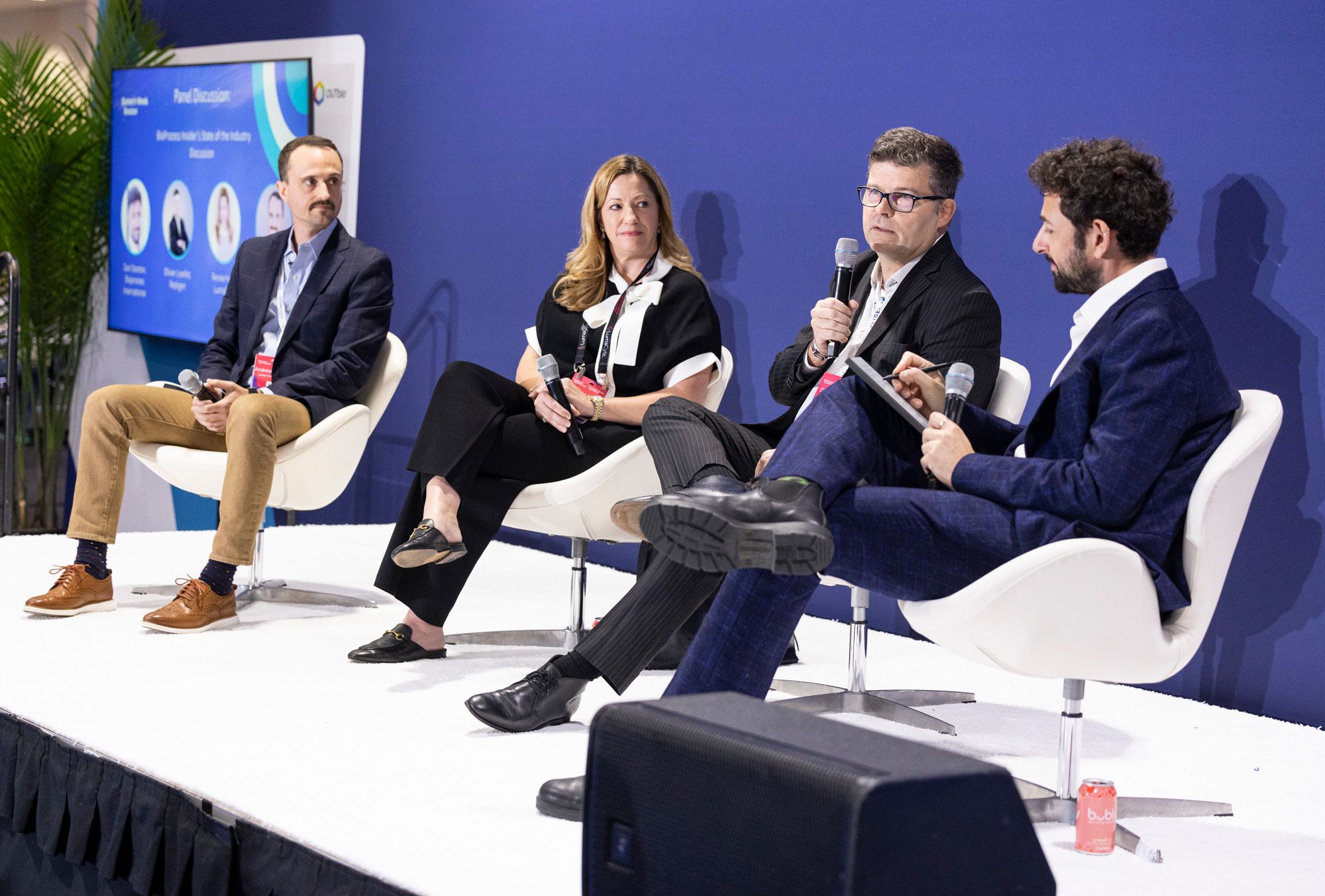 Group of global speakers sitting on a stage and engaging in meaningful discussions