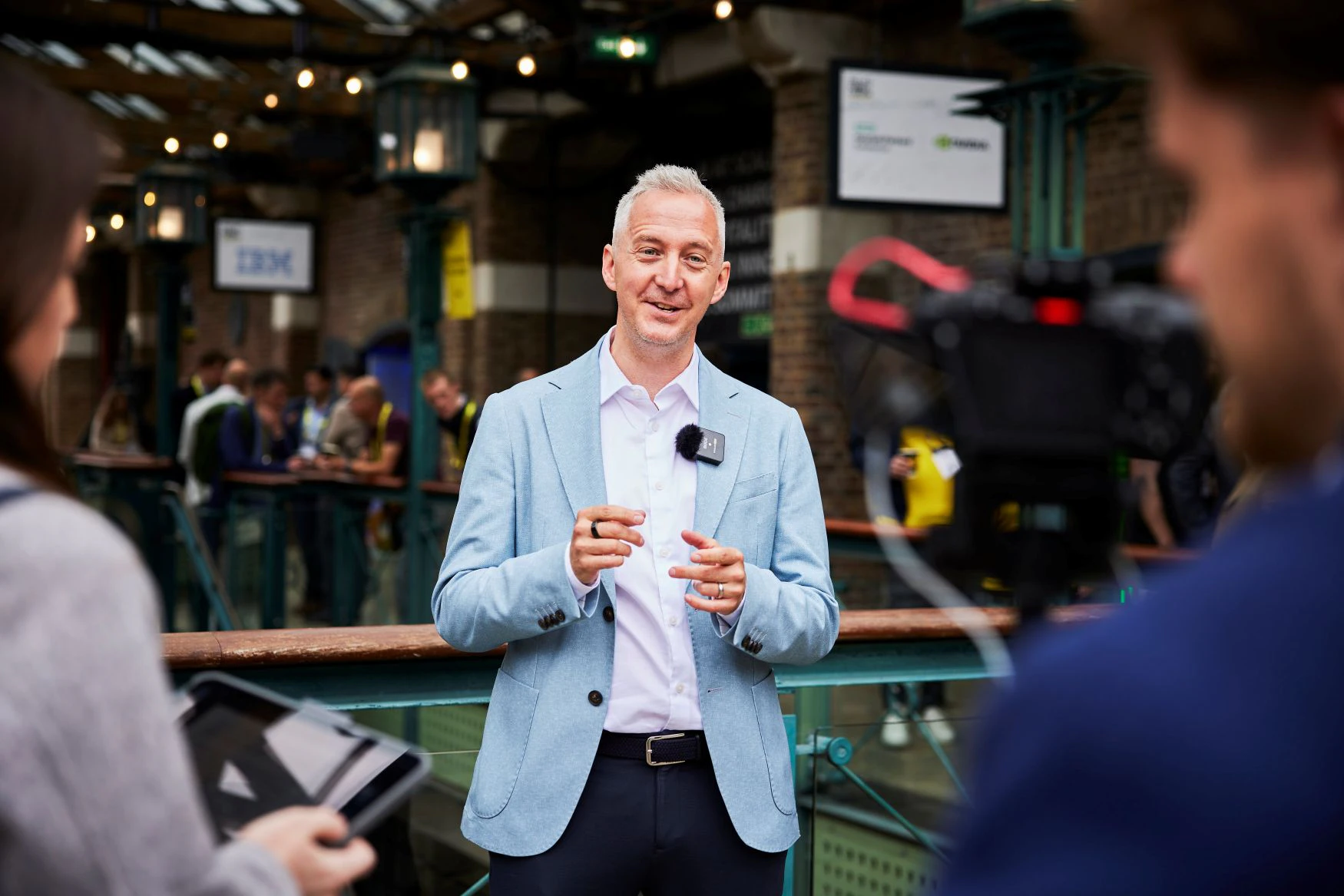 A journalist presents a piece to camera at The AI Summit London