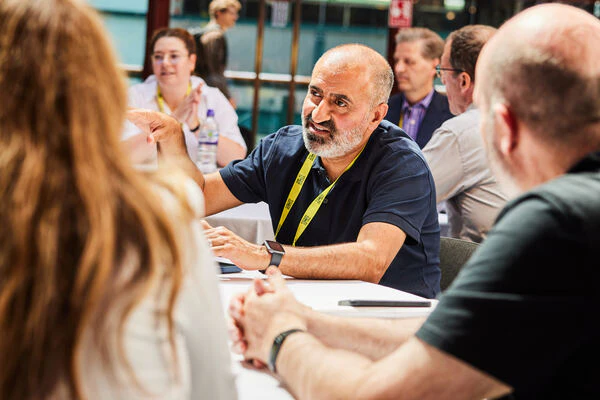 A man joins a roundtable at The AI Summit London and shares an opinion