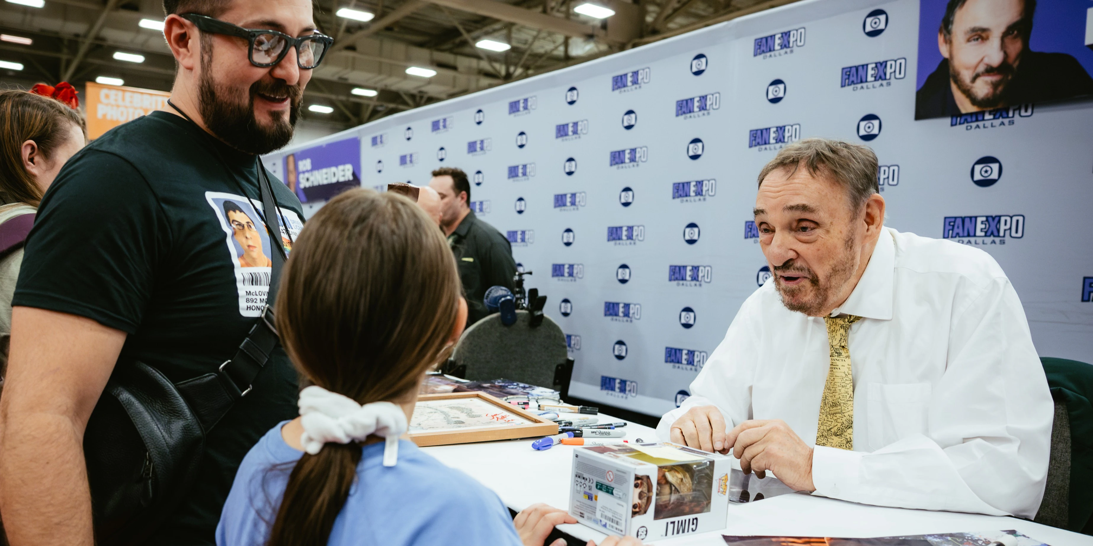 John Rhys-Davies signing memorabilia and meeting fans during an autograph session at FAN EXPO Dallas.