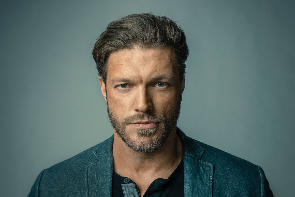 Adam Copeland looks serious into the camera