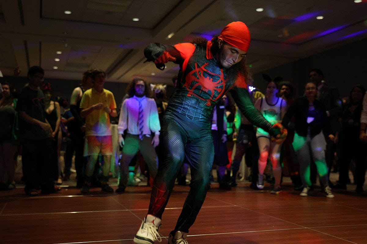 A Miles Morales Cosplayer dances in a dance circle