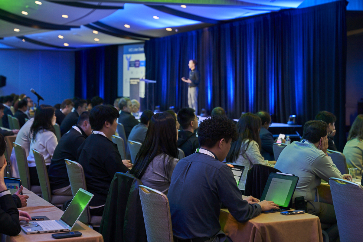 A room full of attendees at Antibody Engineering & Therapeutics watching a speaker present on stage