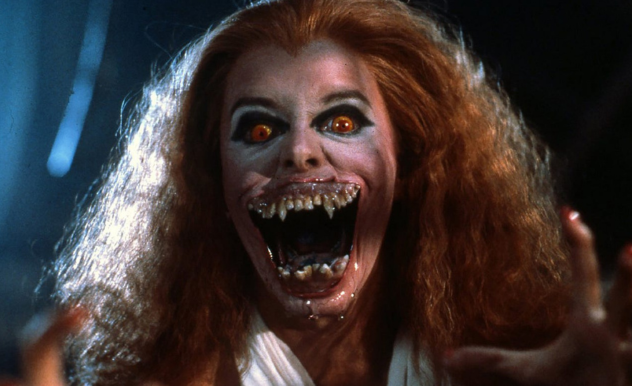 Amy (Amanda Bearse) reaches out towards the camera, mid transformation into a vampire. 