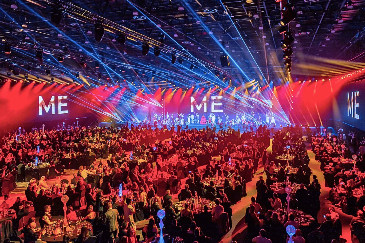Packed ballroom at the Middle East Event Awards 2025 with seated guests, stage lighting, and live entertainment