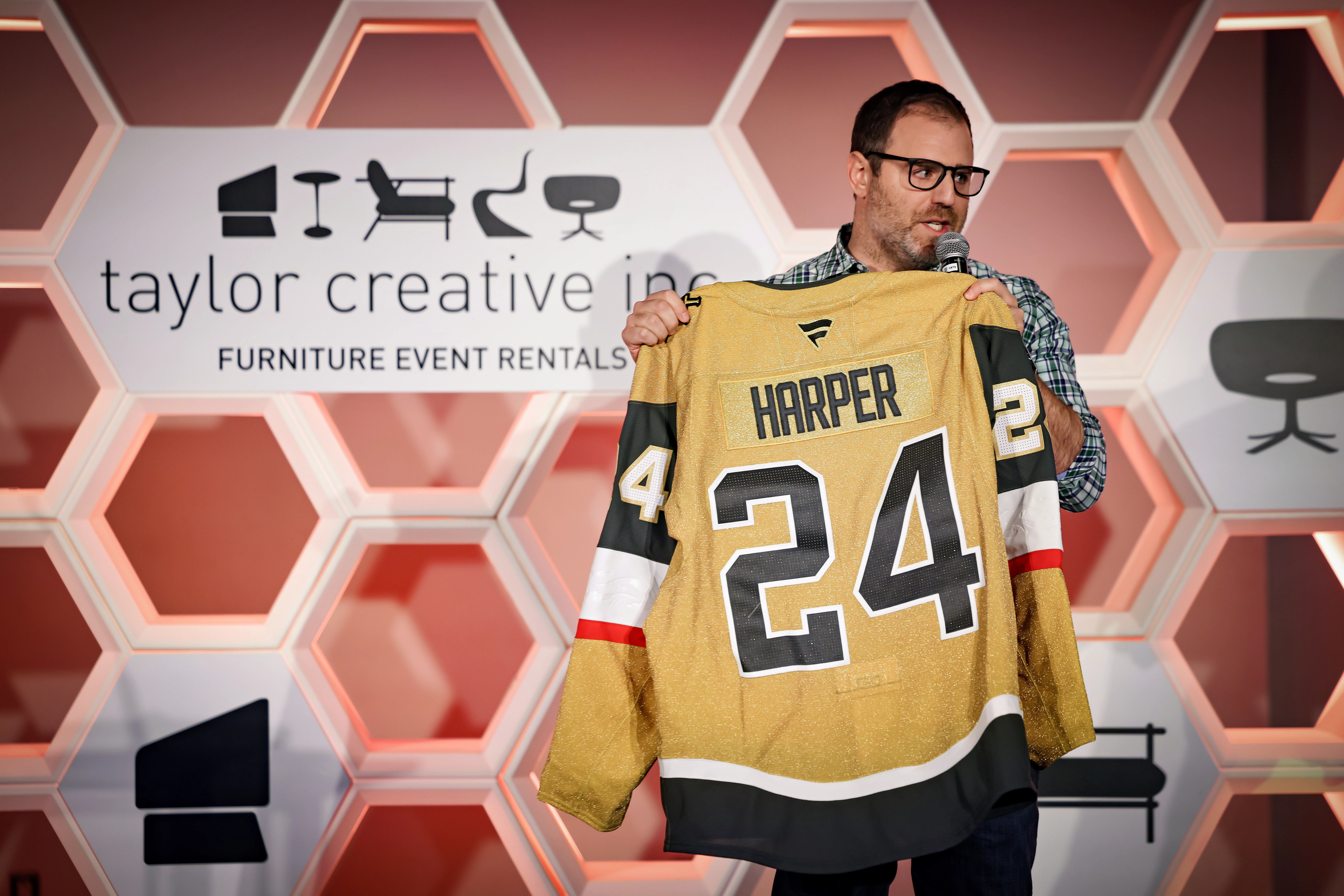 Man speaking while holding jersey