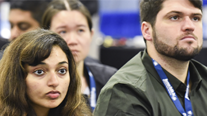 Attendees listening to a conference presentation