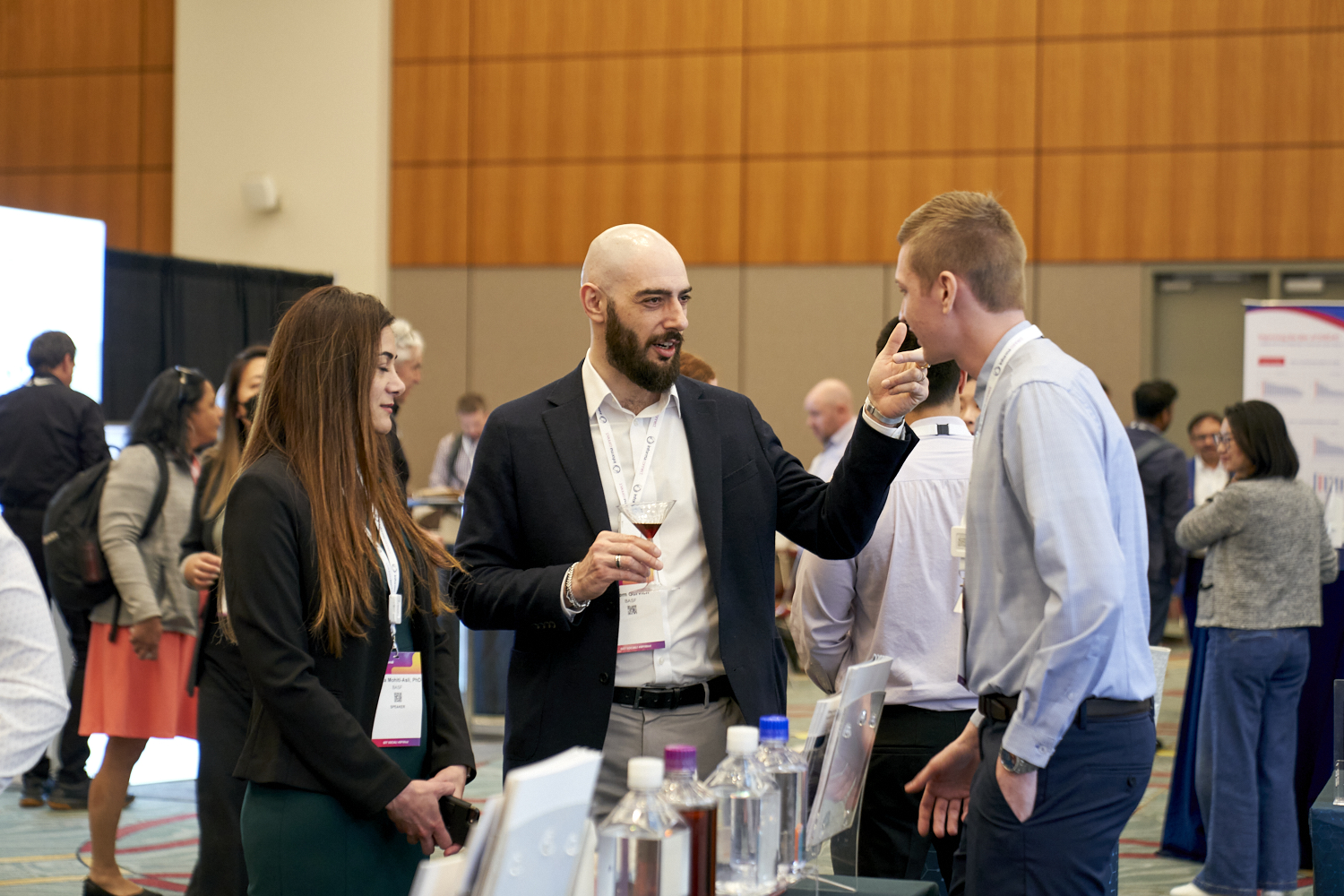 Attendees speak to an exhibitor at BioProcess International