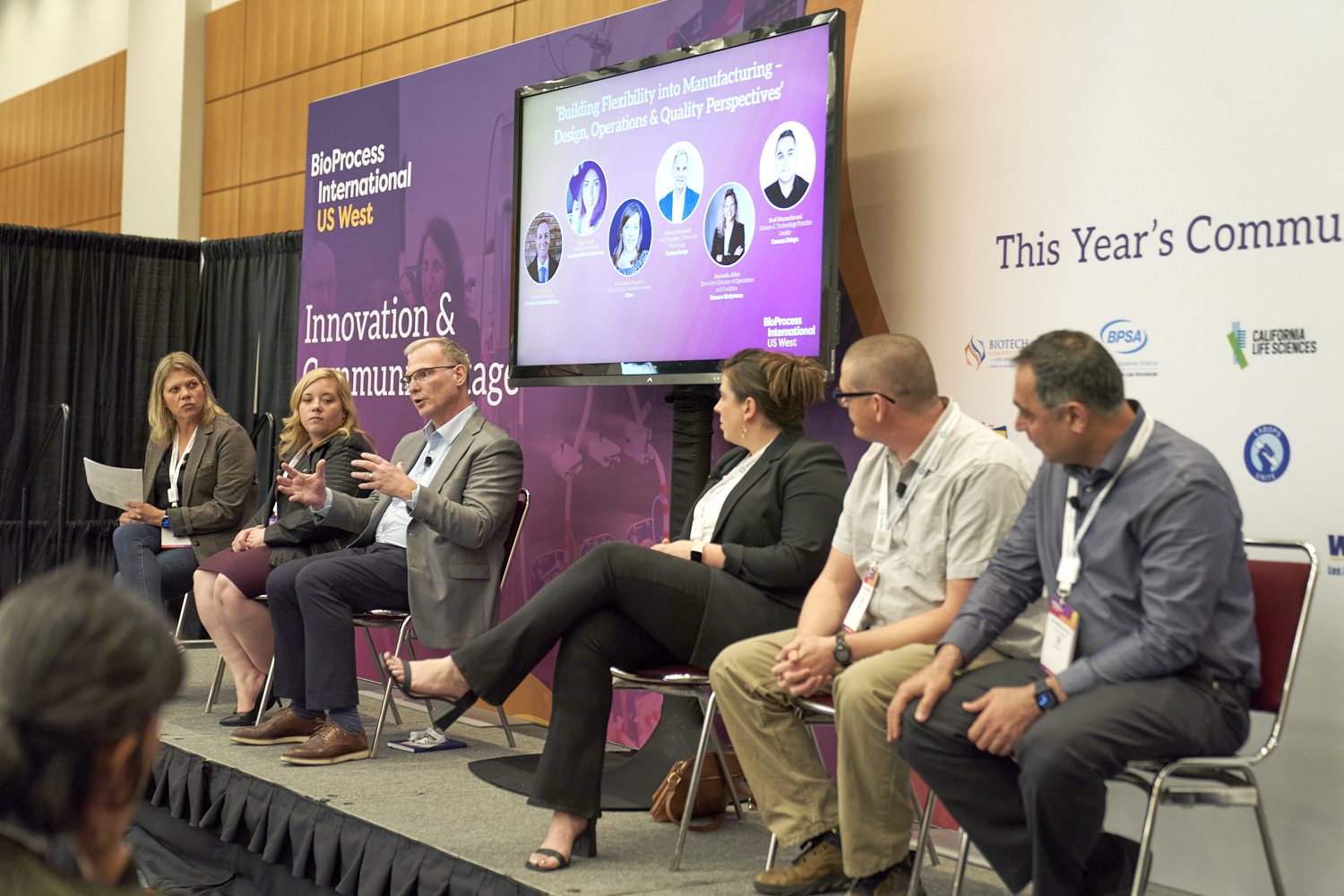 A panel discussion takes place on stage at BioProcess International US West