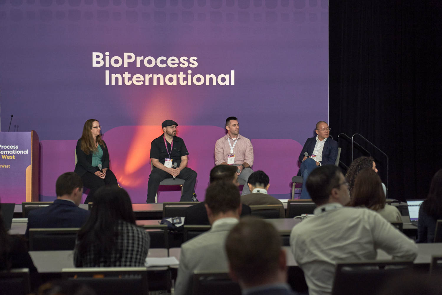 Panellists on stage listening to an audience member ask a question at BPI West in San Diego