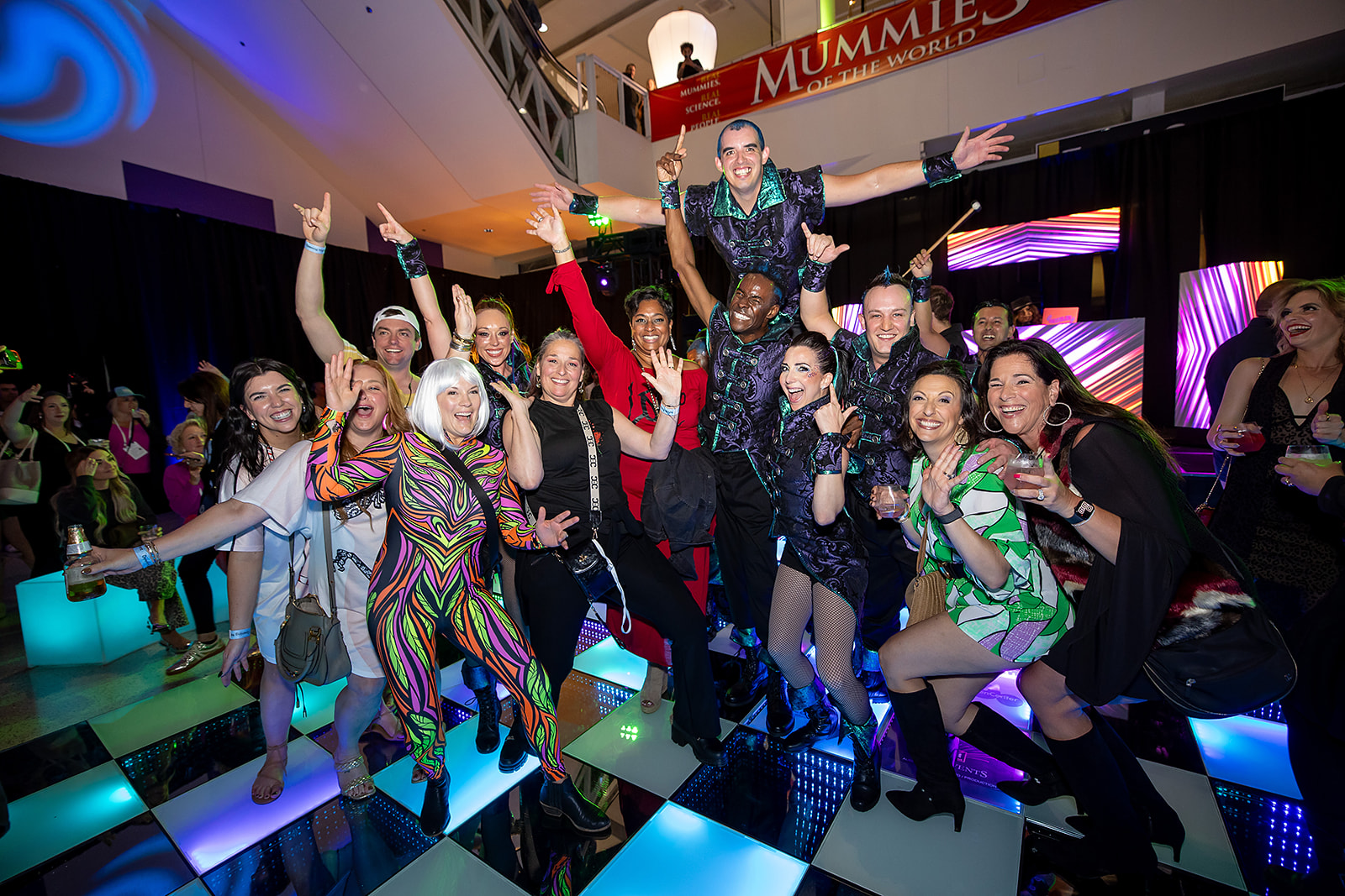 A group of people enjoying their time at the opening night party