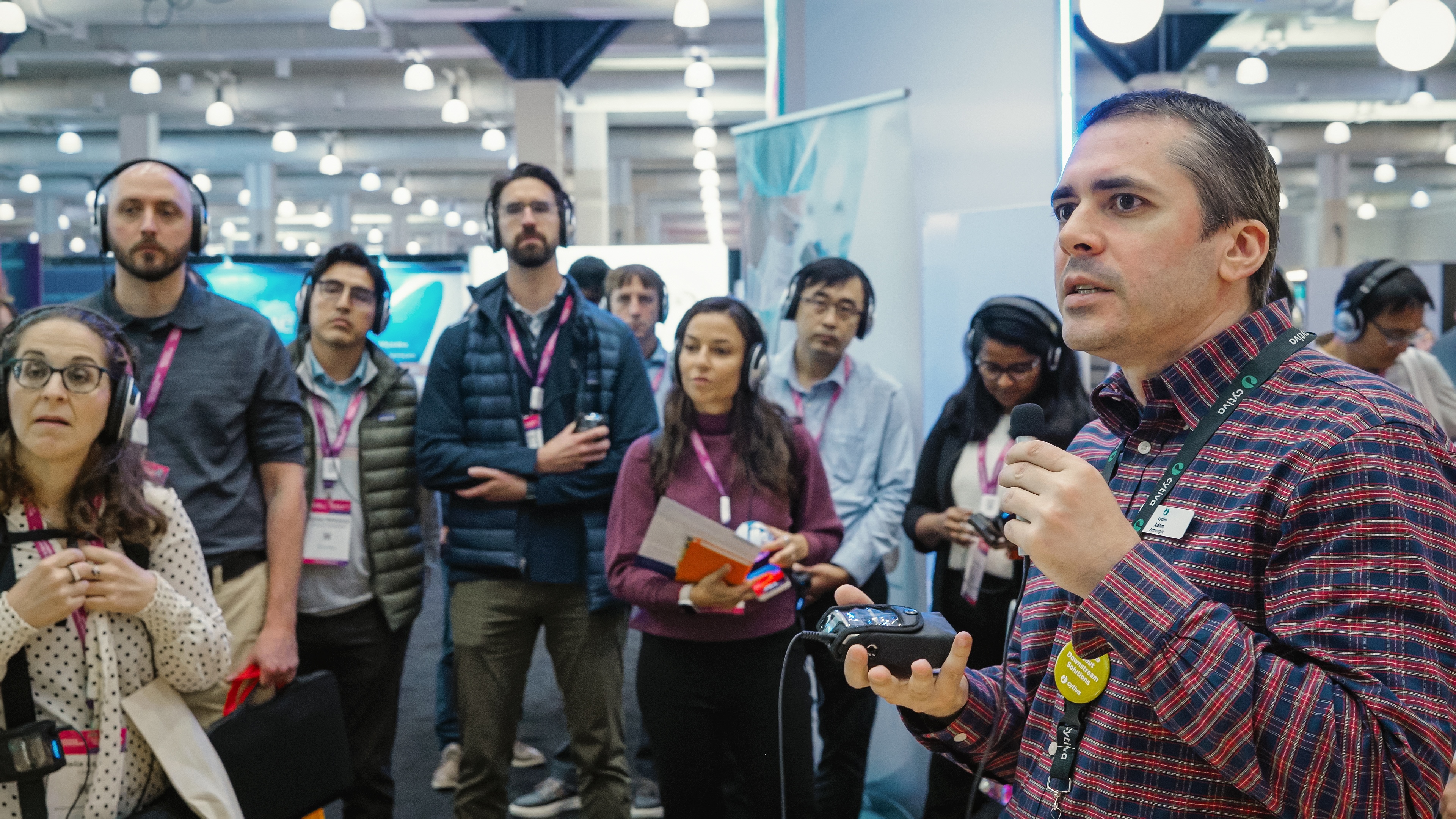 BioProcess International (BPI) attendees gather for a live lab demonstration in the exhibit hall.