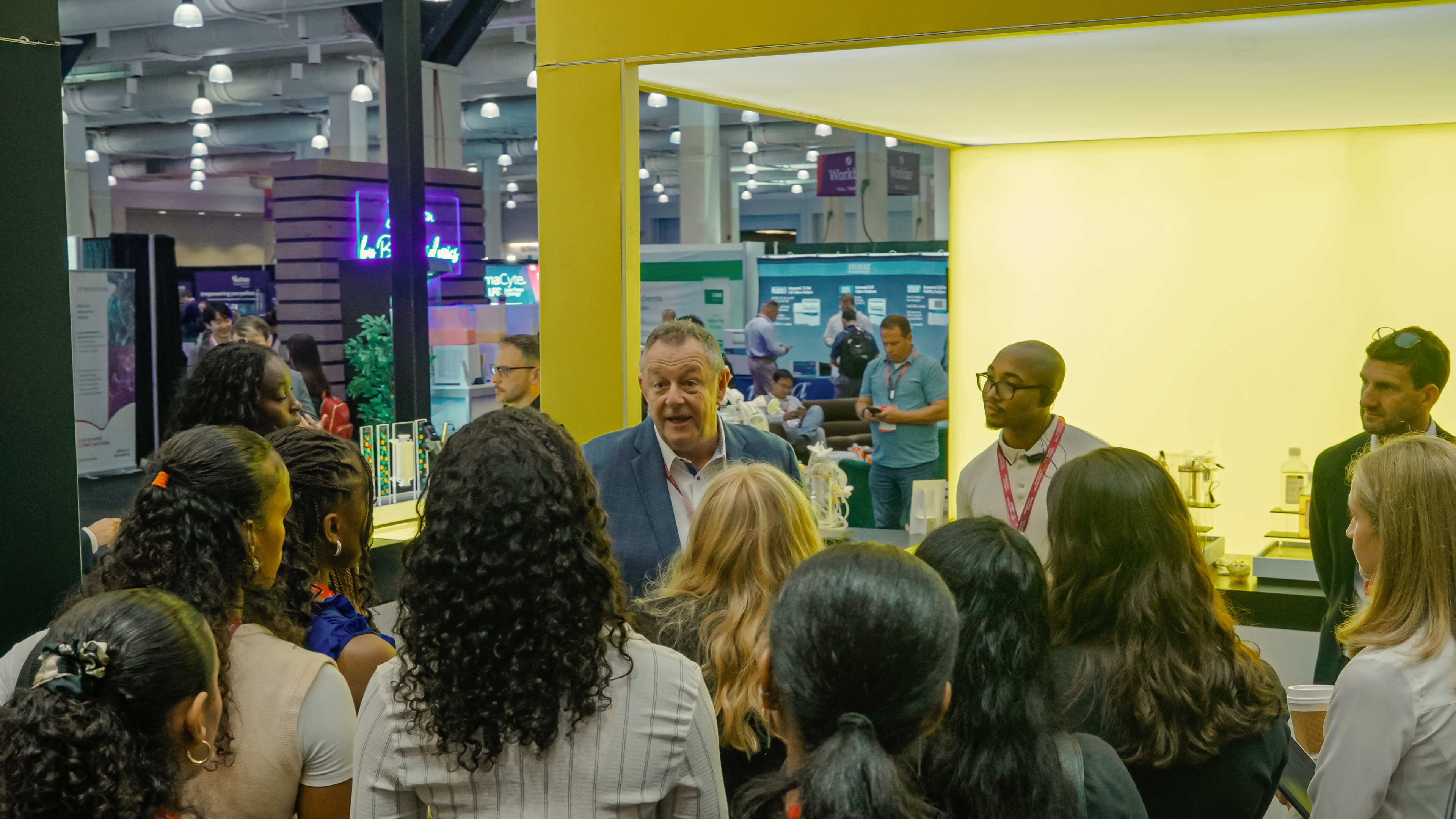 Bioprocessing attendees speaking with exhibitors and booth staff at BioProcess International.