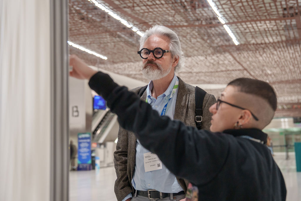 Two people discussing the content of a panel presentation during the panel tour in Barcelona 2025