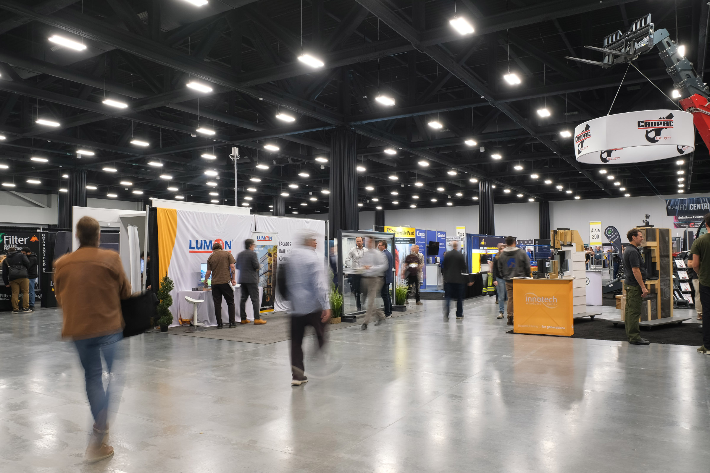 attendees and booths on the BUILDEX trade show floor