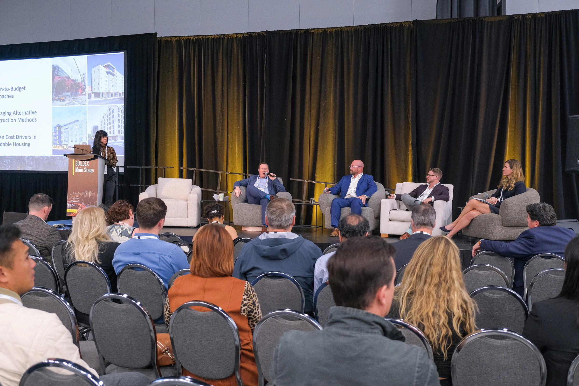 BUILDEX Alberta Main Stage session, with 5 speakers on stage presenting to the audience