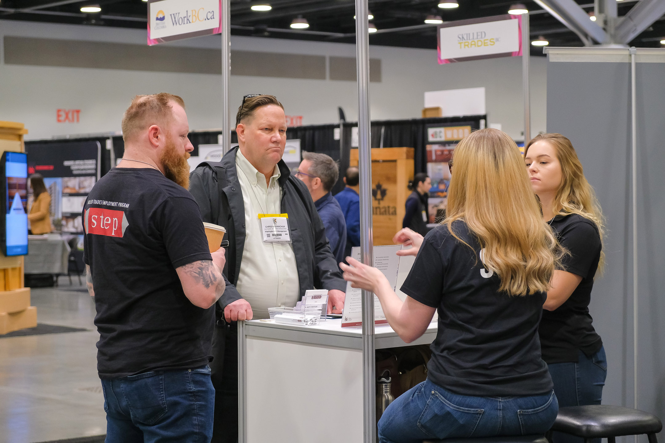 Closeup of the Workforce Solutions Centre tradeshow feature from BUILDEX Vancouver showing several kiosks with people engaged in conversation