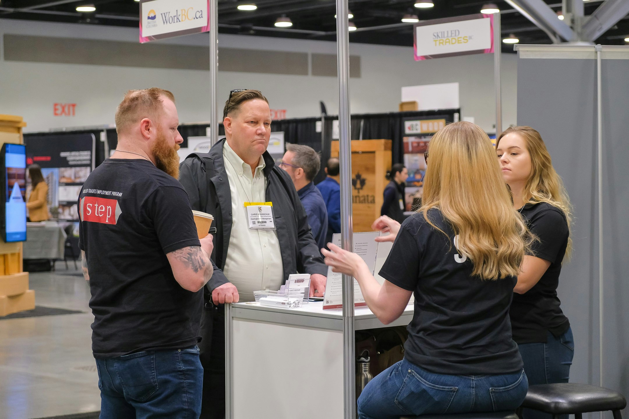 Closeup of the Workforce Solutions Centre tradeshow feature from BUILDEX Vancouver showing several kiosks with people engaged in conversation