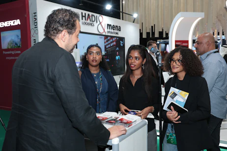 Attendees networking with exhibitors on the SES 2025 show floor in Riyadh