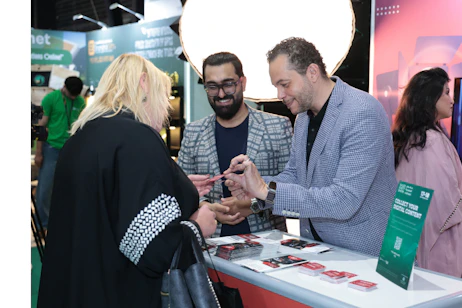 Visitors discussing creative event solutions and partnerships at SES 2025 in Riyadh