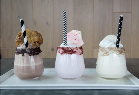 3 glasses of chocolate, strawberry, and vanilla pudding